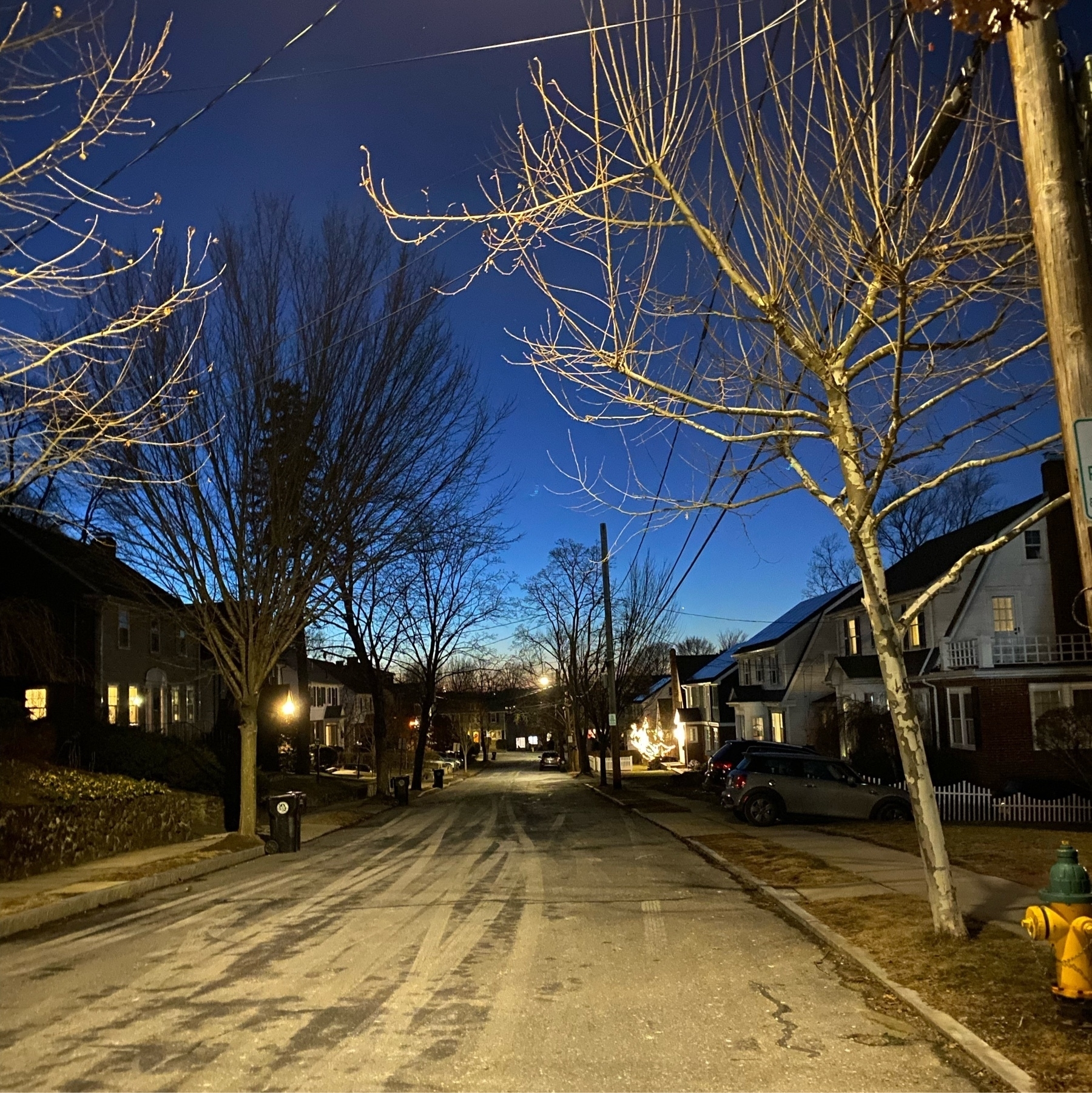 Street view in the evening illuminated by streetlights.
