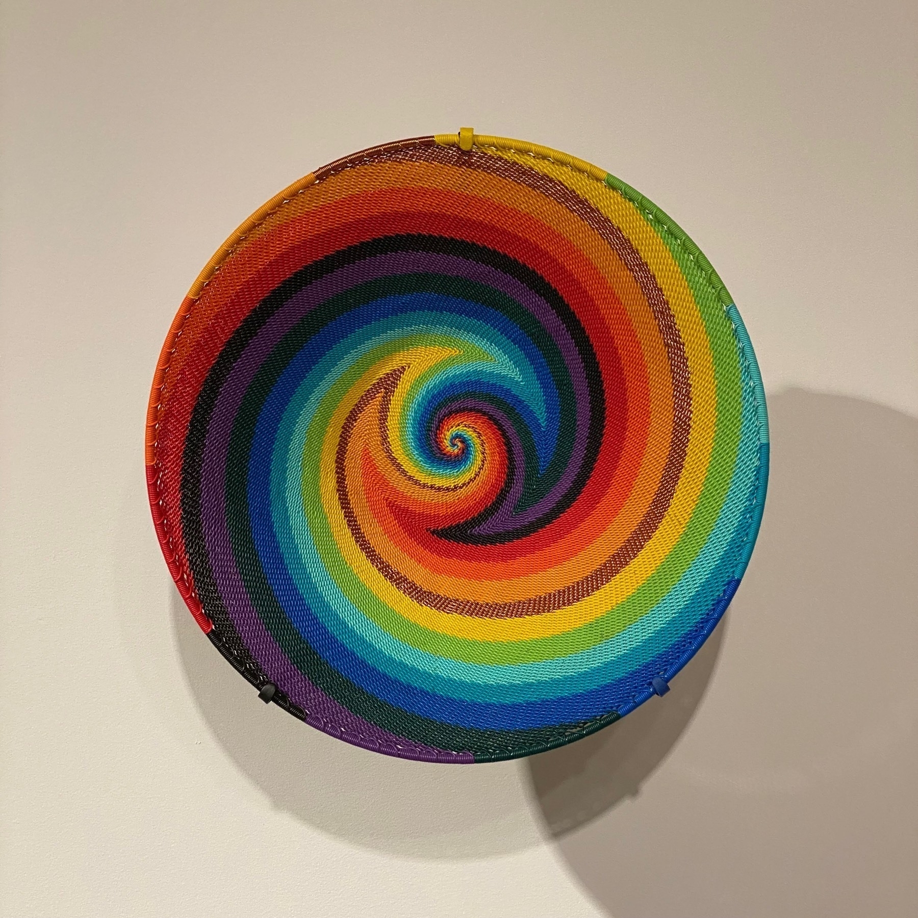 Bowel woven from brightly colored telephone wire.