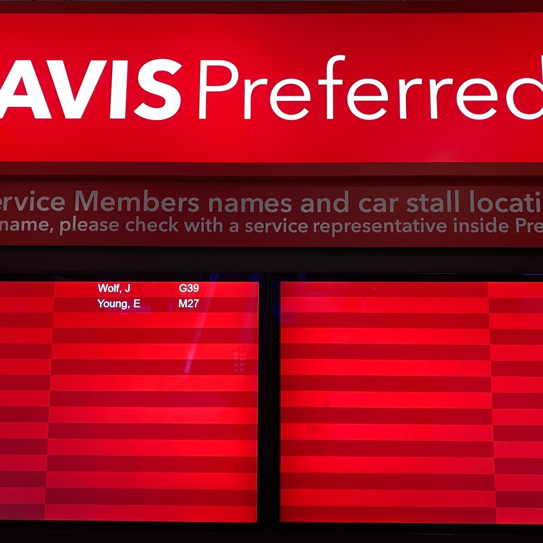 Red sign which says "Avis Preferred".