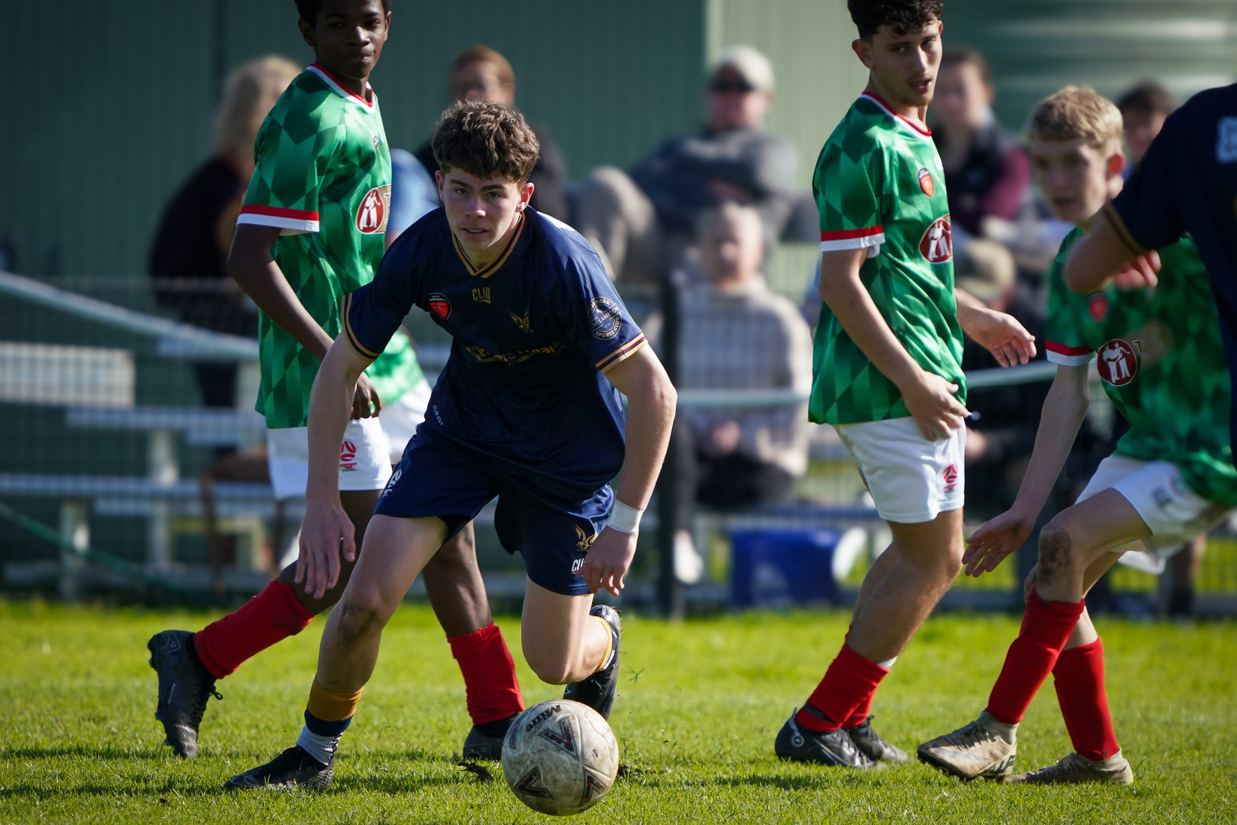 Several young soccer players are actively engaged in a game on a grassy field.