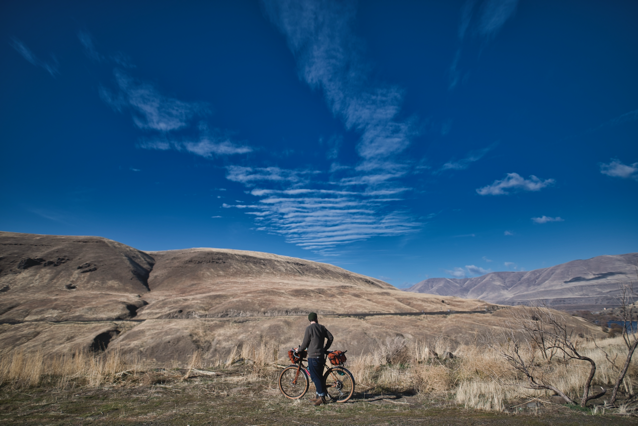 The author stands behind his bike by the Deschutes River.
