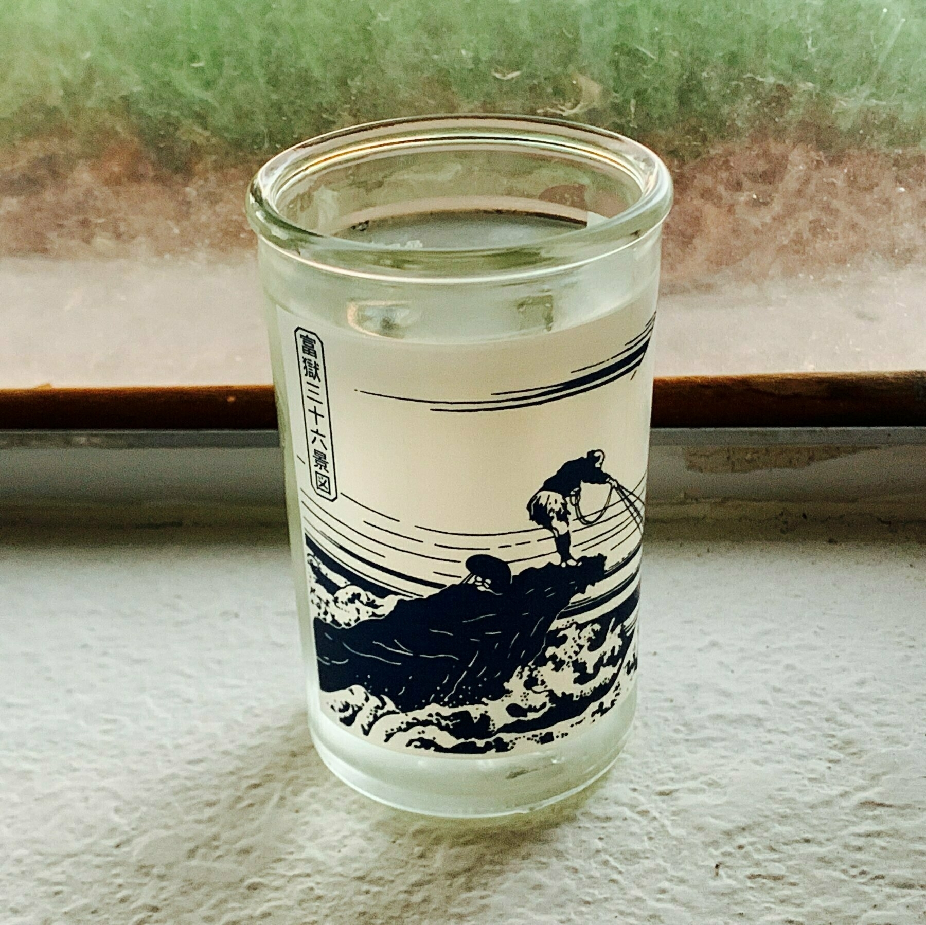cup sake on a window ledge