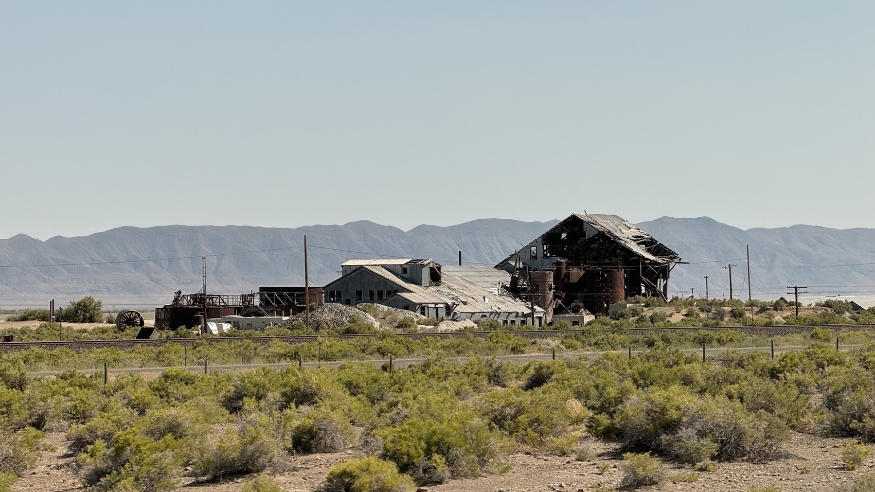 Decrepit buildings with mountains in the distance 