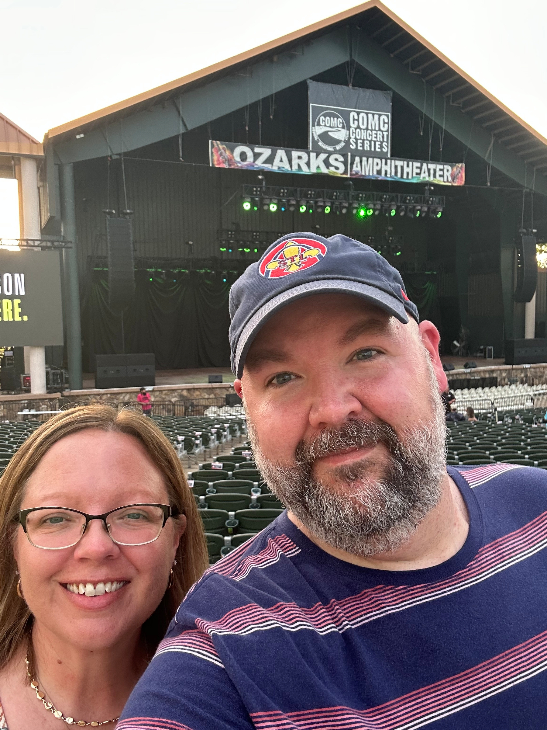 My sister and I take a selfie in front of an empty outdoor stage at the Ozarks Amphitheater.