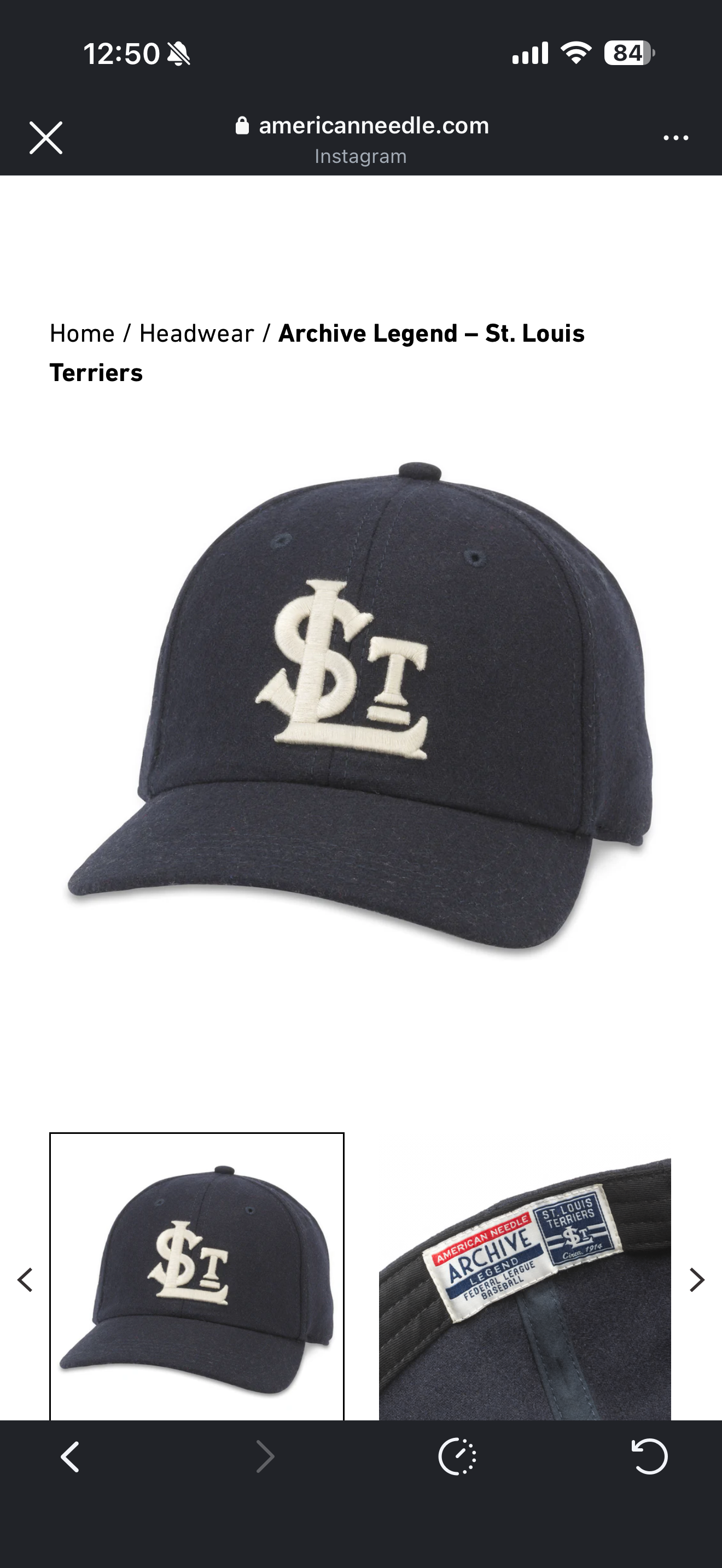 A navy blue baseball cap features the logo STL in white, representing the St. Louis Terriers, with a close-up of the label.