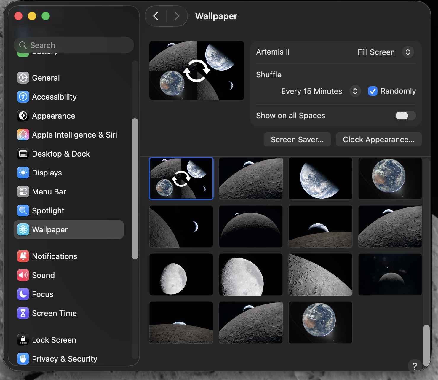 A computer screen displays a system settings menu focused on choosing a moon and Earth-themed wallpapers from  the Artemis II NASA mission