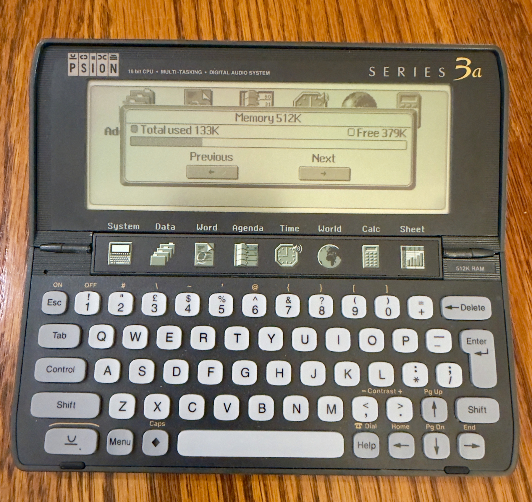 Auto-generated description: A vintage Psion Series 3a palmtop computer displaying a memory status screen.