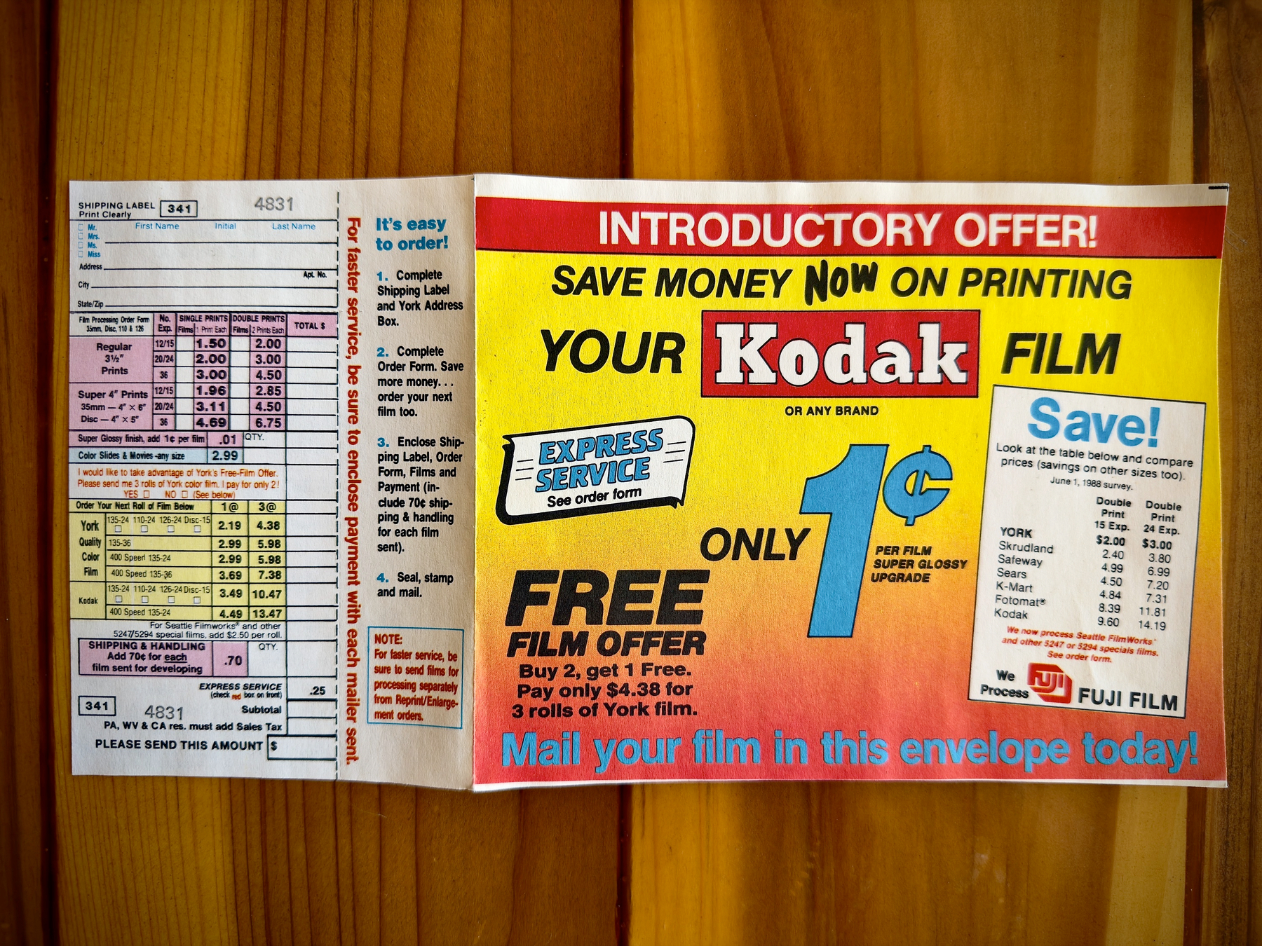 Auto-generated description: An advertisement promoting an introductory offer for Kodak film printing at one cent per print with a free film offer from Express Service, including instructions and a shipping label.