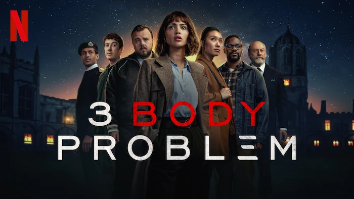 Auto-generated description: A group of people stands against a starry night sky backdrop with a building silhouette, promoting the Netflix series 3 Body Problem.