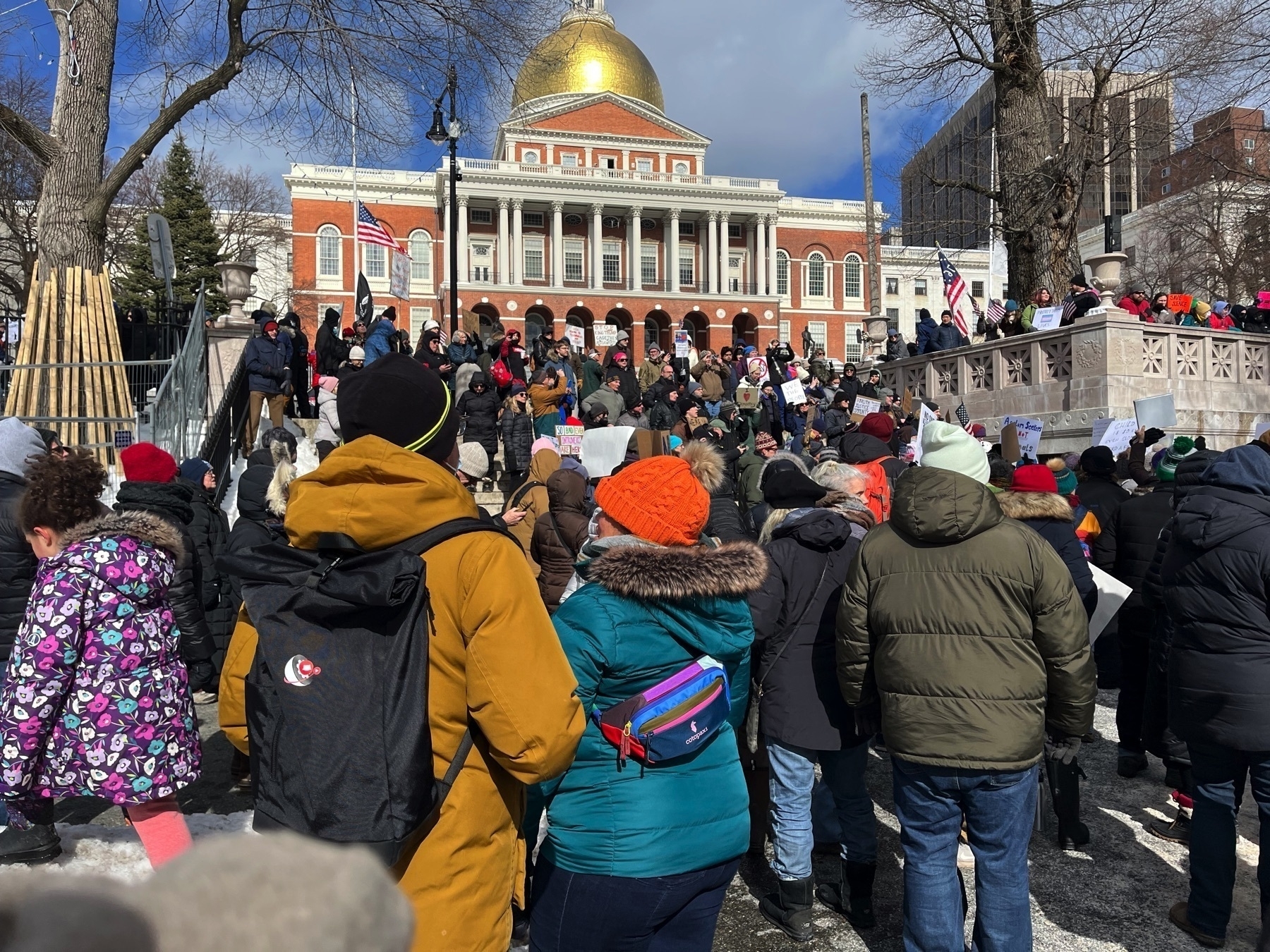 A big crowd of people in front of the Massachusetts State House.