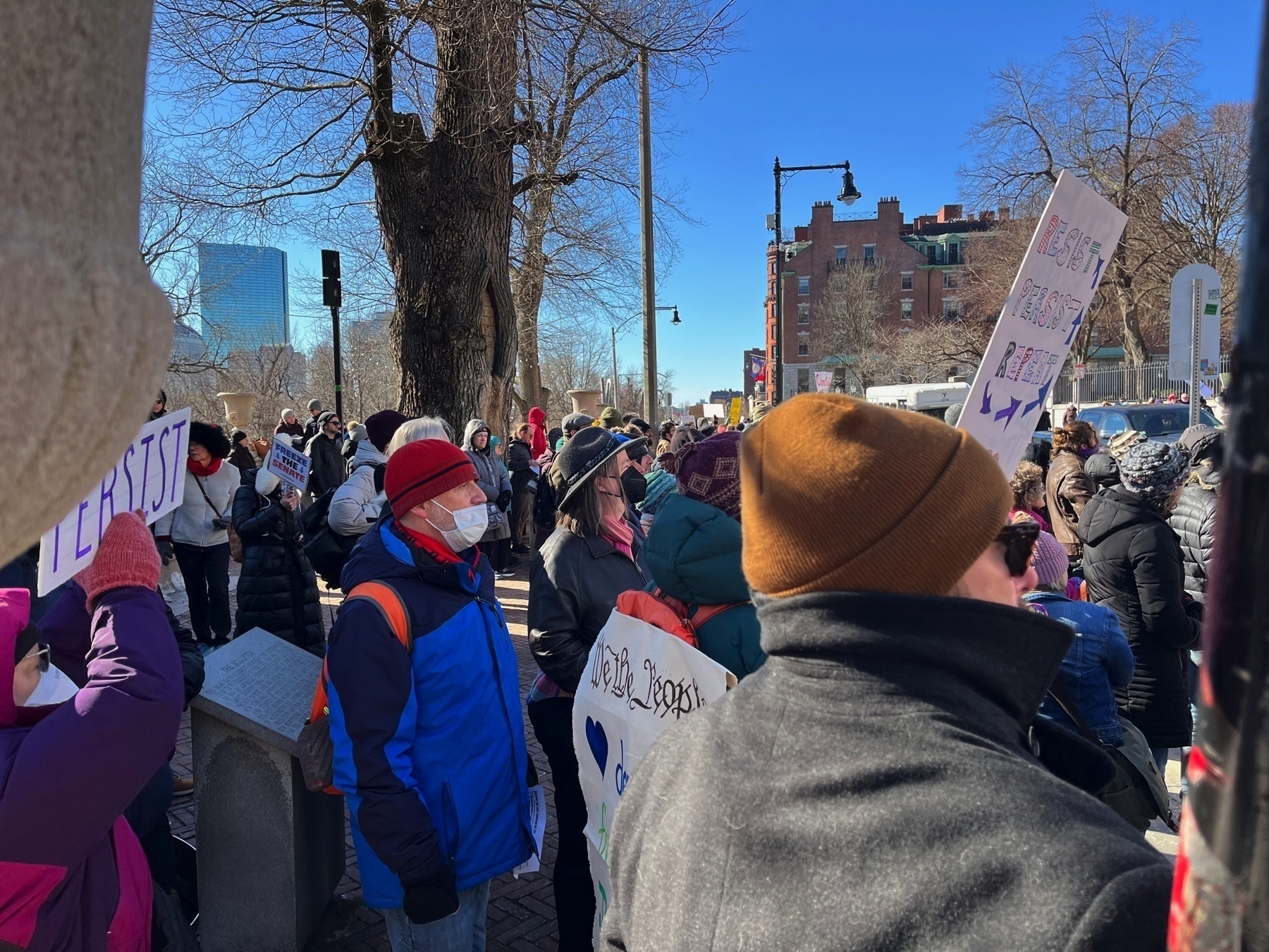 A big crowd, a few with signs.