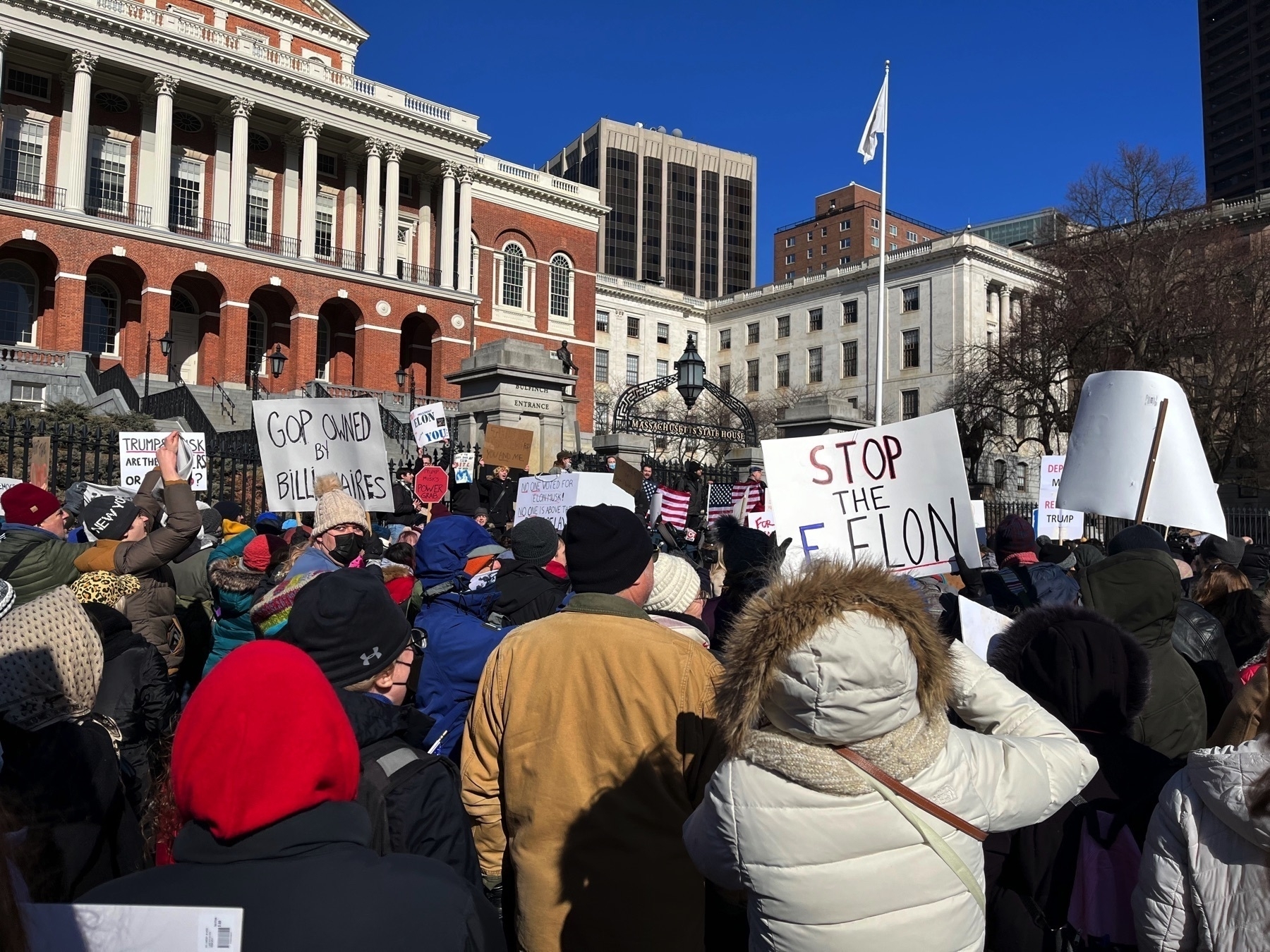 One sign says ”stop the felon”. Another says ”GOP owned by billionnaires”.