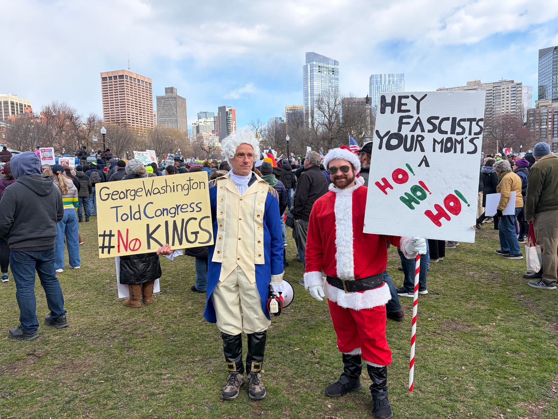 A protester in a George Washington outfit, and a protester in a Santa outfit.