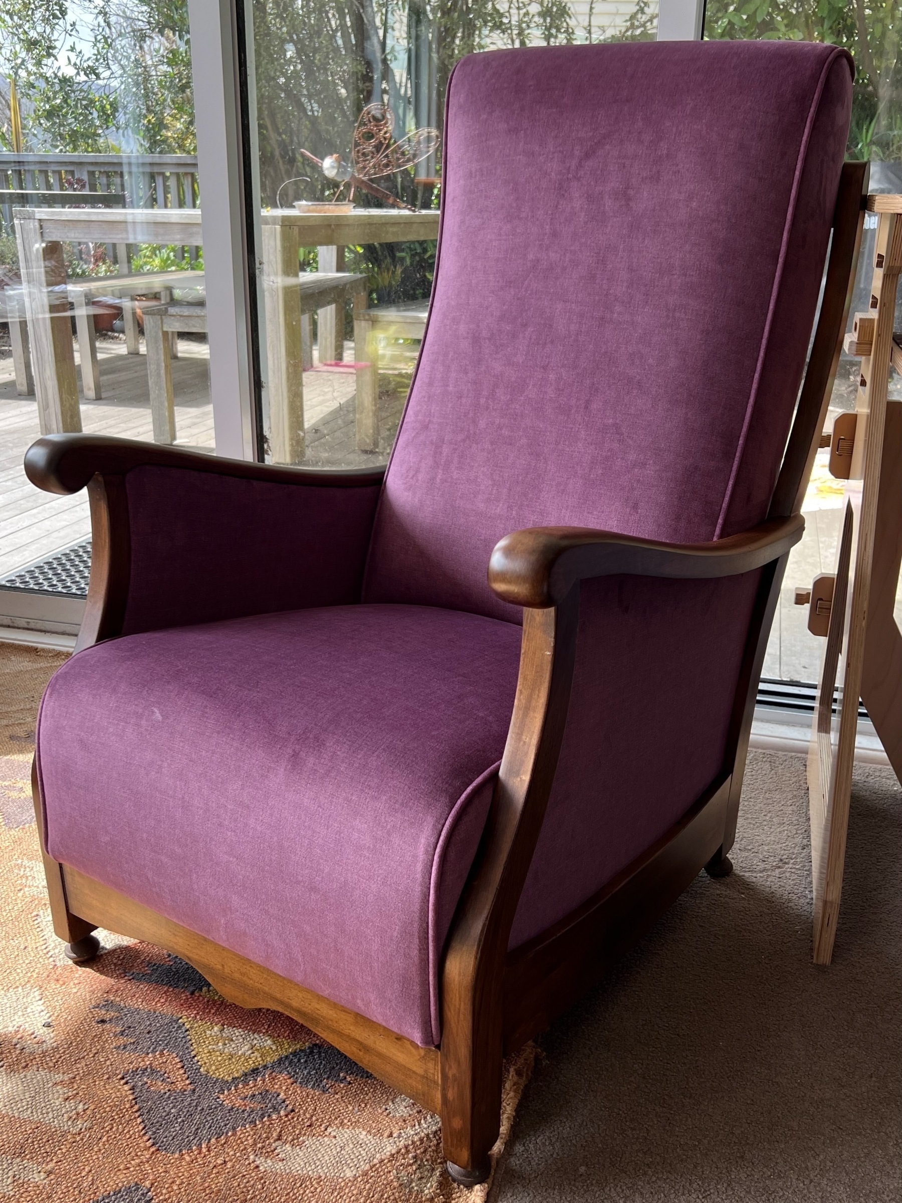 A fireside chair covered in purple waterfall velvet. It looks very comfy (spoiler: it is comfy).