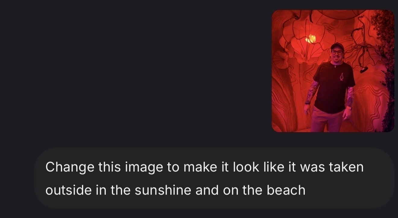 Auto-generated description: A person stands in a room illuminated with red lighting, surrounded by abstract designs.