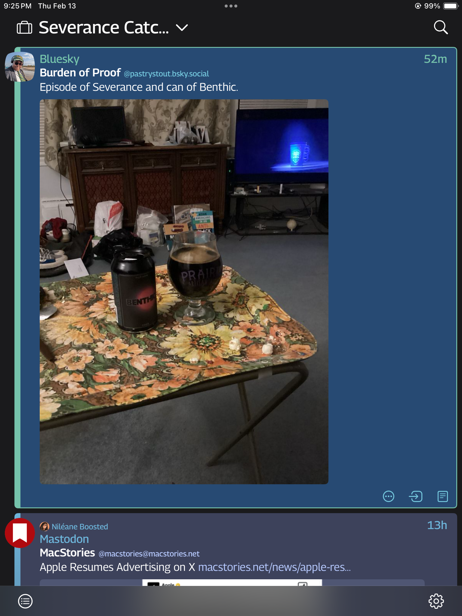 A post shows a can of Benthic beer and a glass filled with its contents on a floral-patterned table with a TV with Succession playing in the background. 