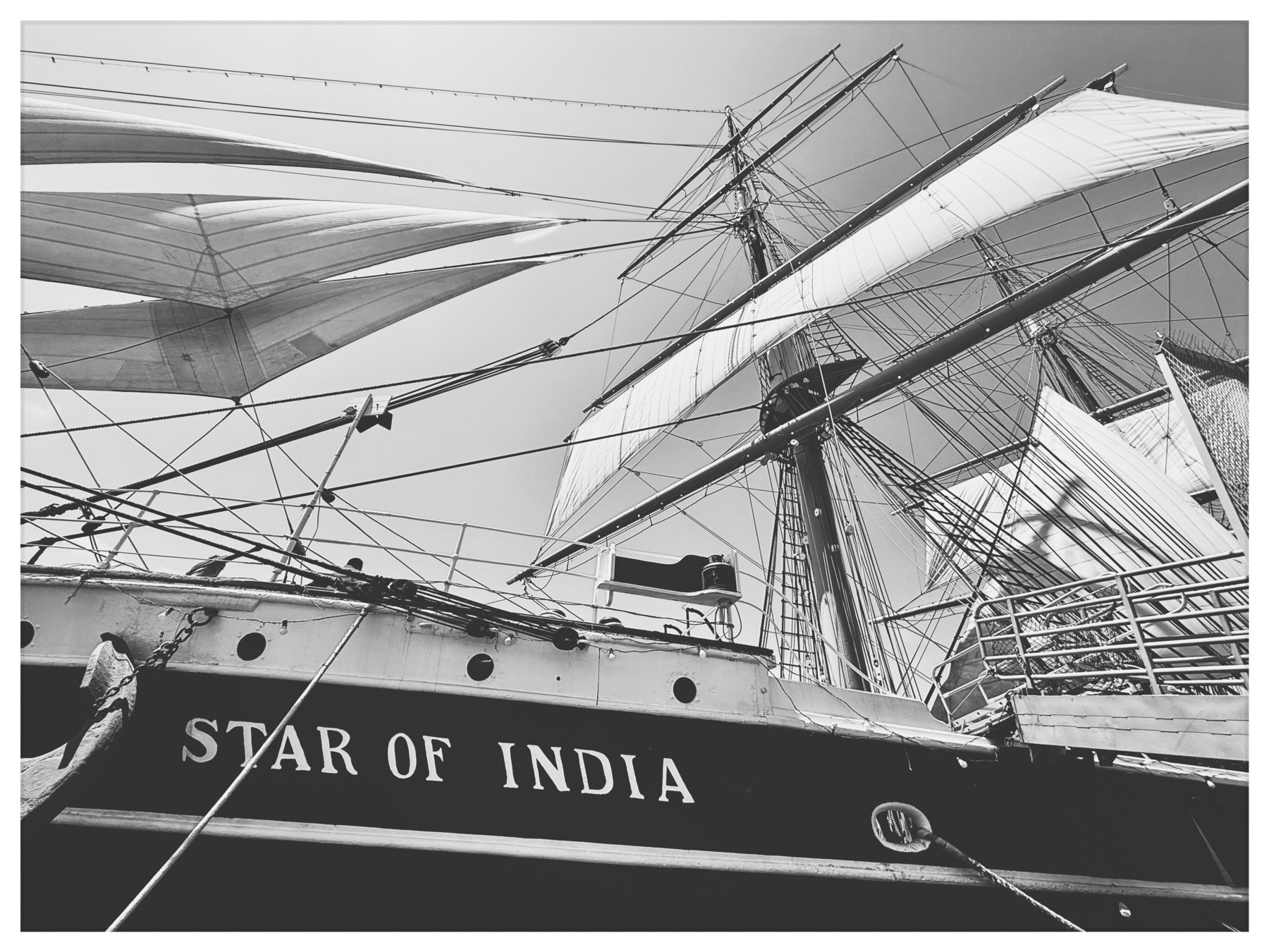 Auto-generated description: A black and white photograph captures the rigging and sails of the historic sailing ship Star of India.