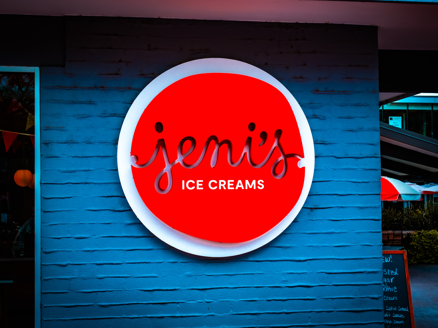 A red and white sign reads Jeni's Ice Creams on a blue wall.