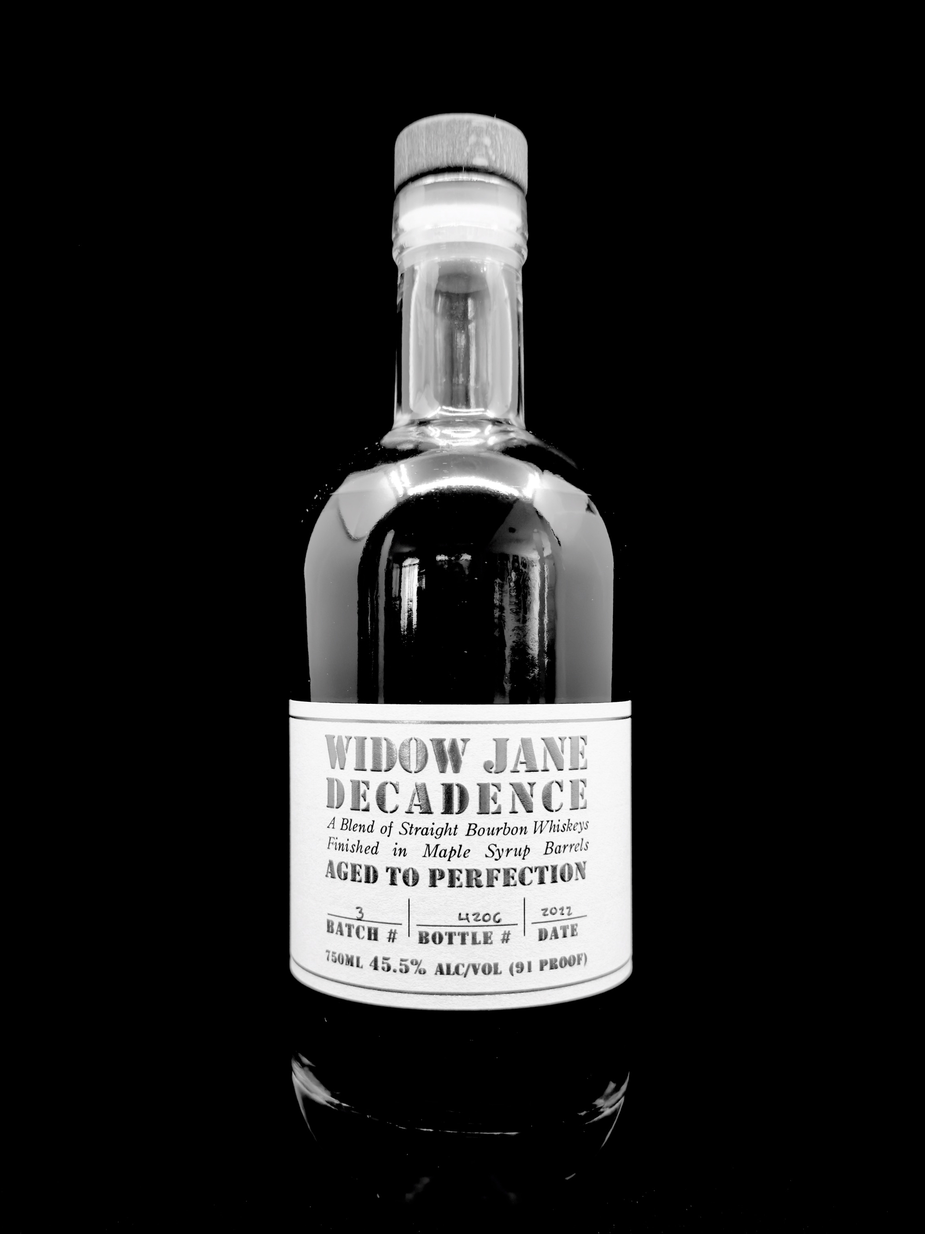 Auto-generated description: A bottle of Widow Jane Decadence bourbon whiskey is pictured against a black background.