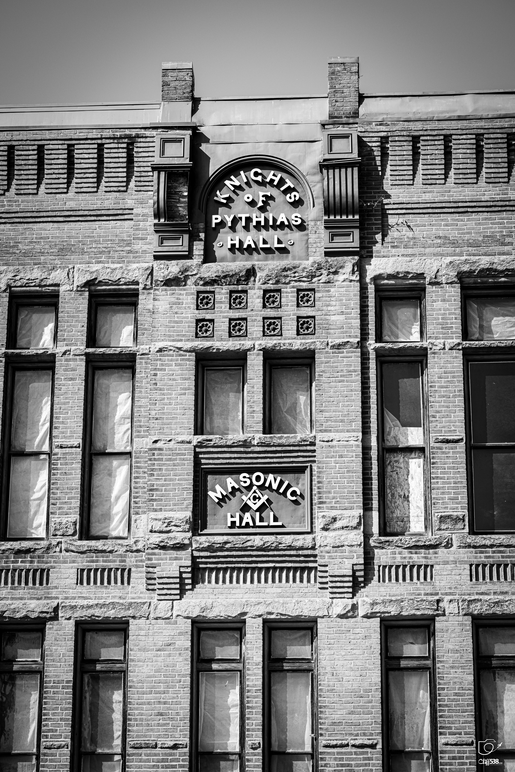 Auto-generated description: A historic brick building with signage indicating it is the Knights of Pythias Hall and Masonic Hall.