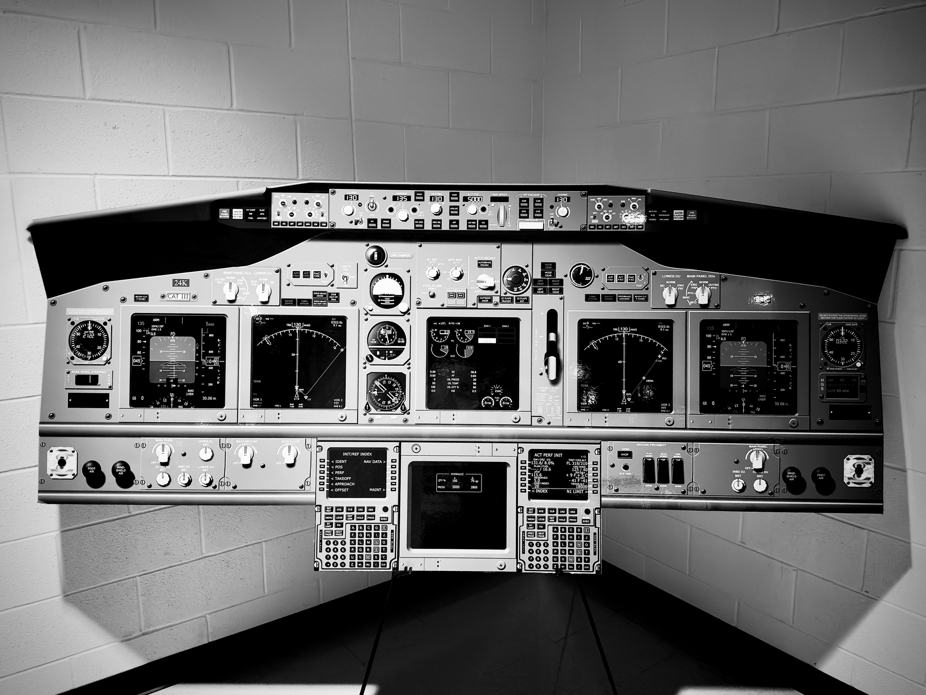 Auto-generated description: A cockpit panel with various instrumentation and controls is displayed against a plain background.