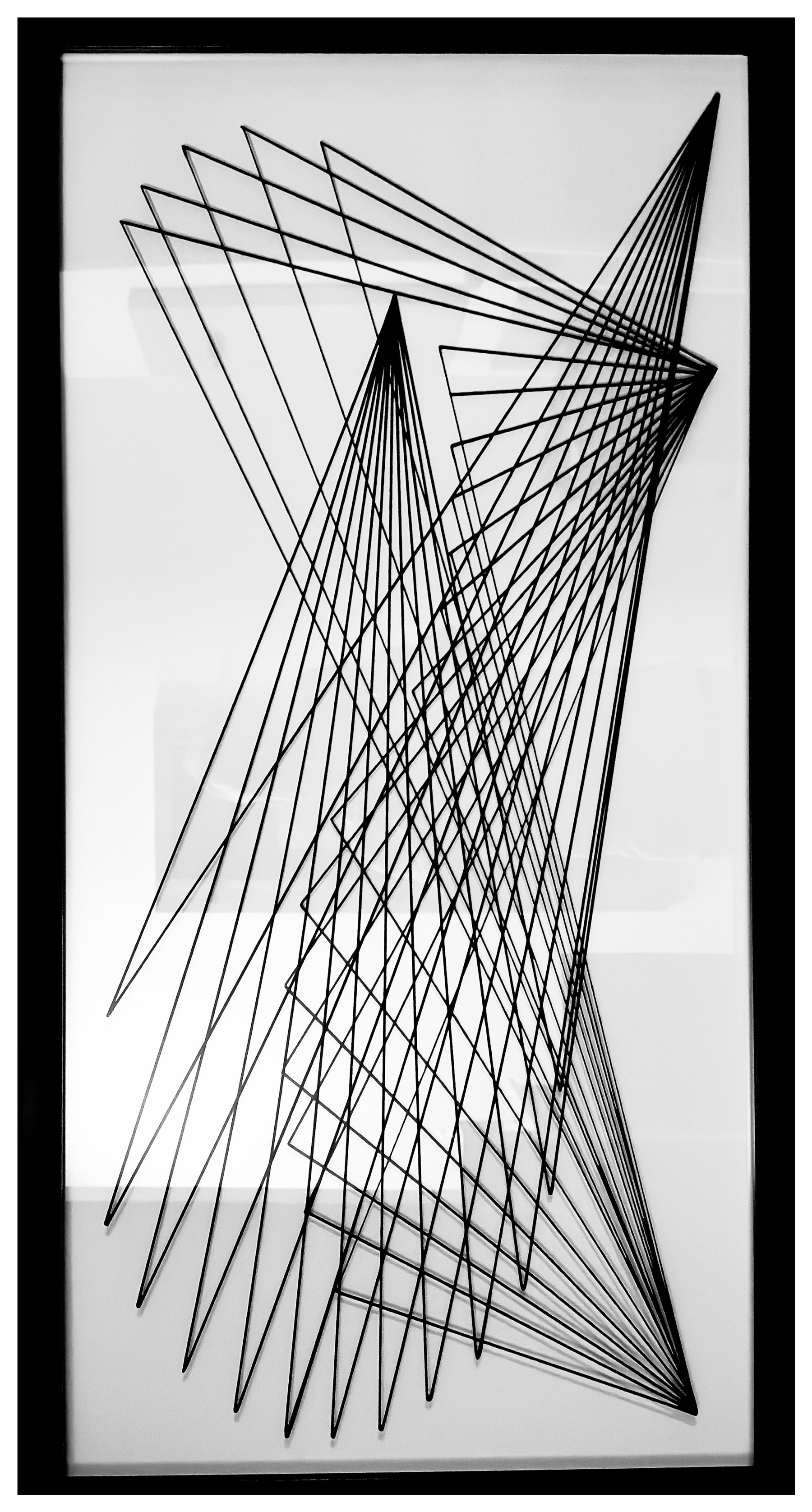 Auto-generated description: A series of intersecting black geometric lines form a complex pattern on a white background.