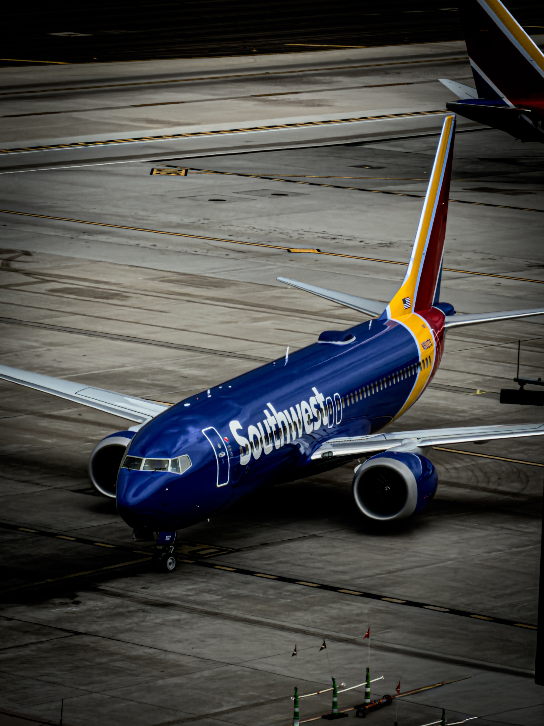 Auto-generated description: A Southwest Airlines plane is positioned on an airport tarmac, ready for departure or arrival.