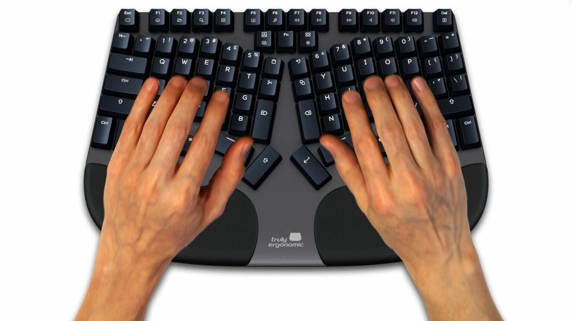 Auto-generated description: A person is typing on a black ergonomic keyboard with curved, split key sections.