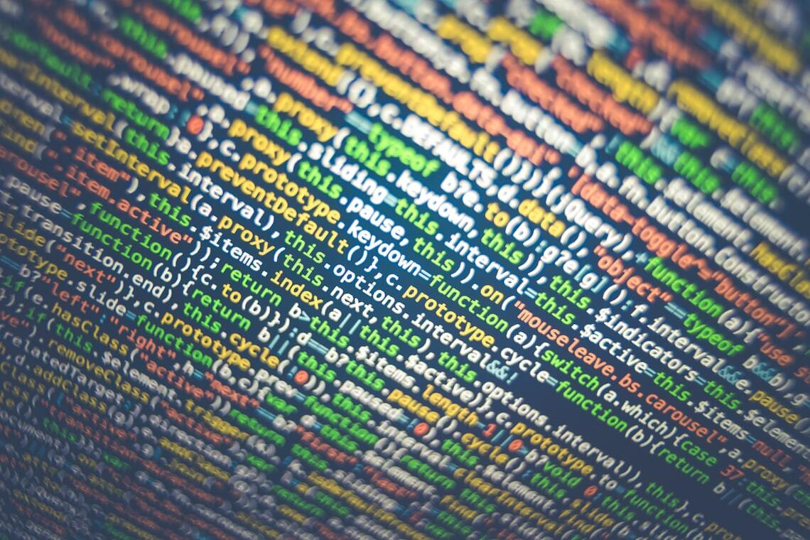 Photo by Markus Spiske / Unsplash. A screen displaying colorful lines of computer code in various programming languages.