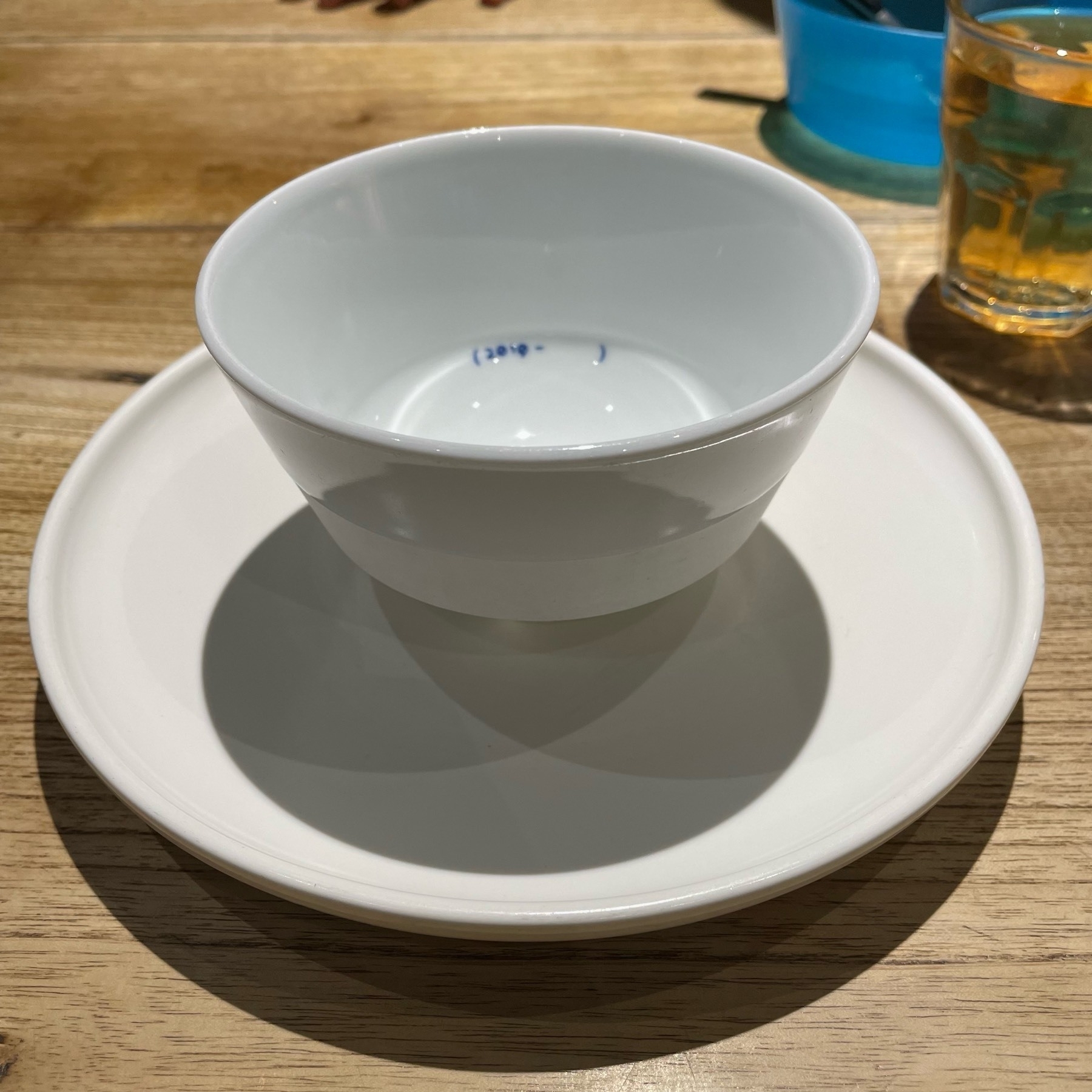 Small white bowl on a white plate