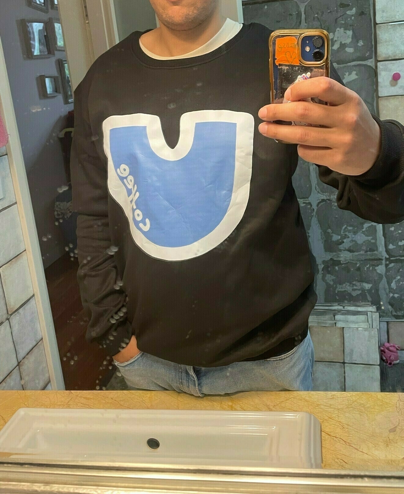 man wearing a jumper that has a giant U on it with the word coffee inside