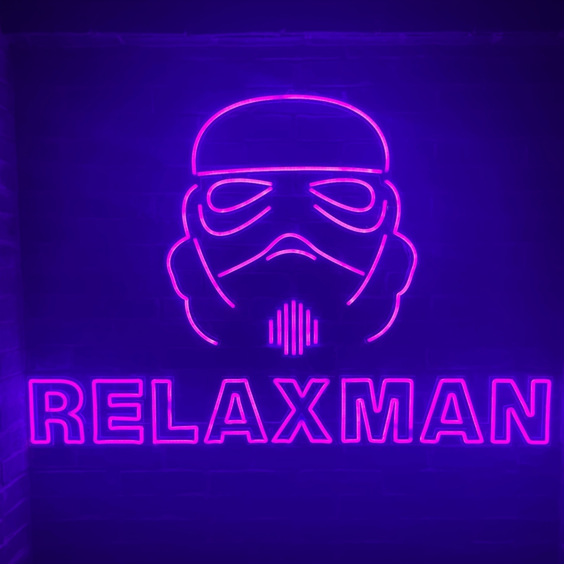Stormtrooper outline in pink lighting with word “relaxman” underneath