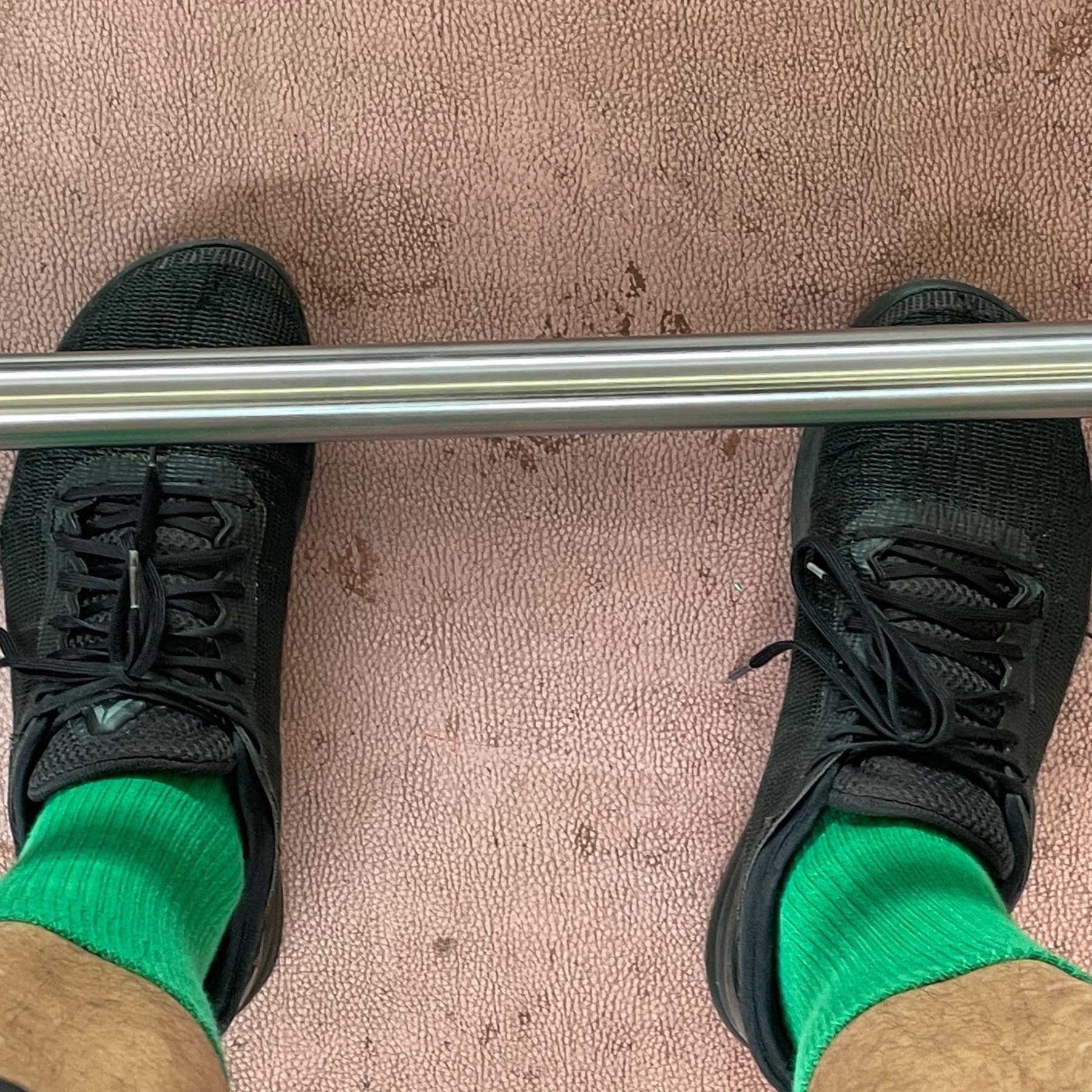 Cropped shot of shoes and a barbell