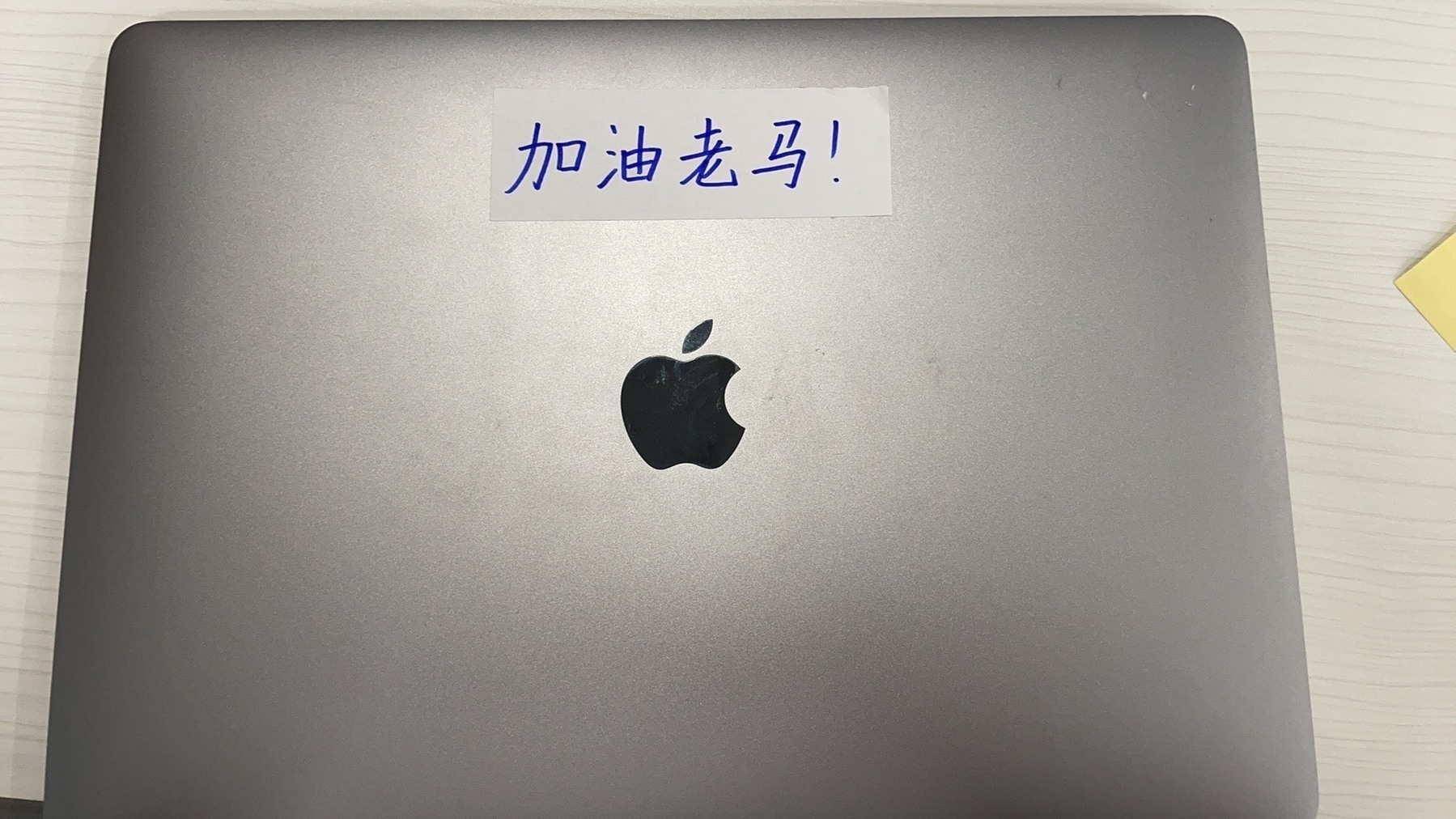 MacBook Air with Chinese characters on a white sticker