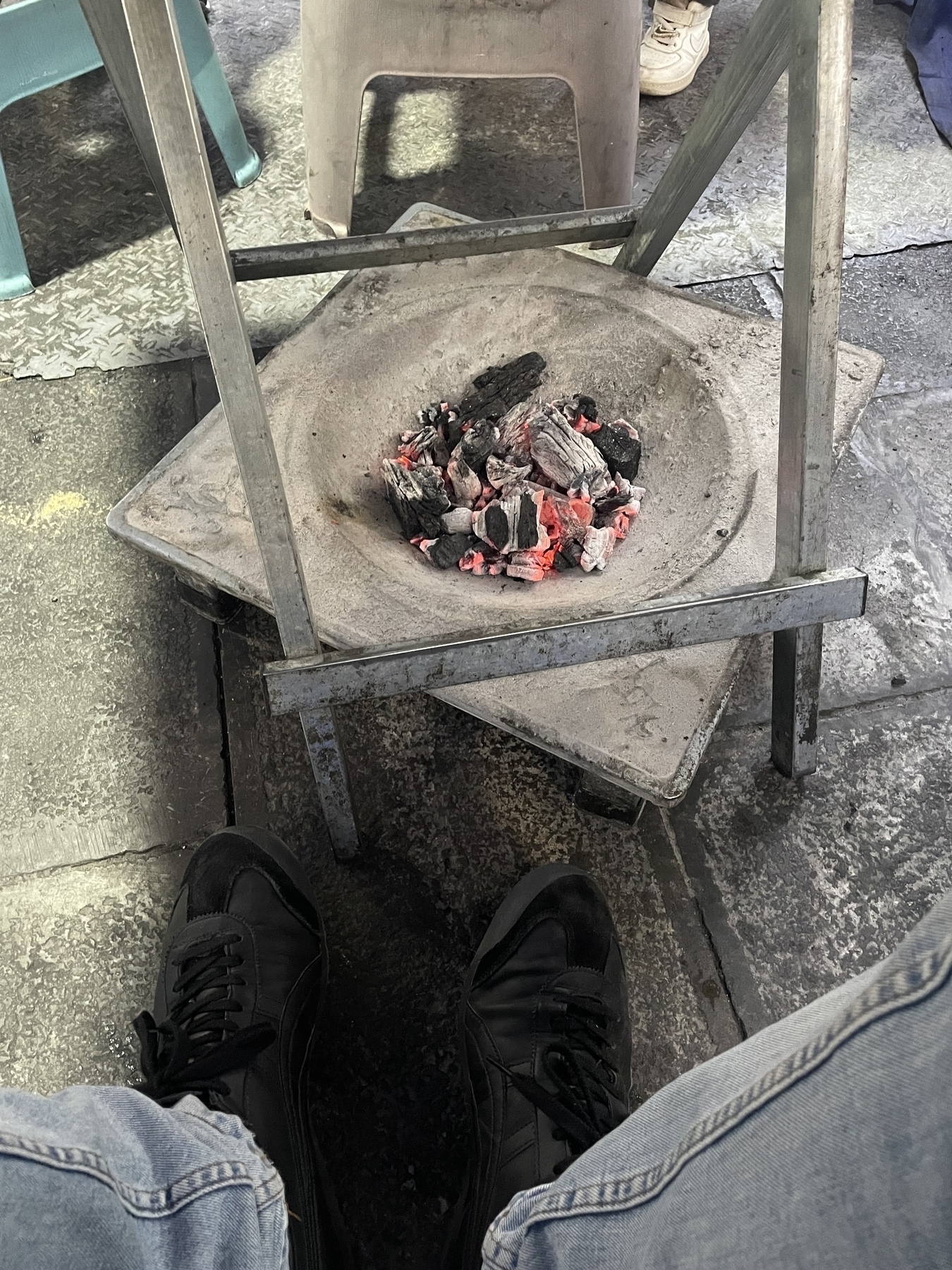 Hot coals under the table to keep warm.