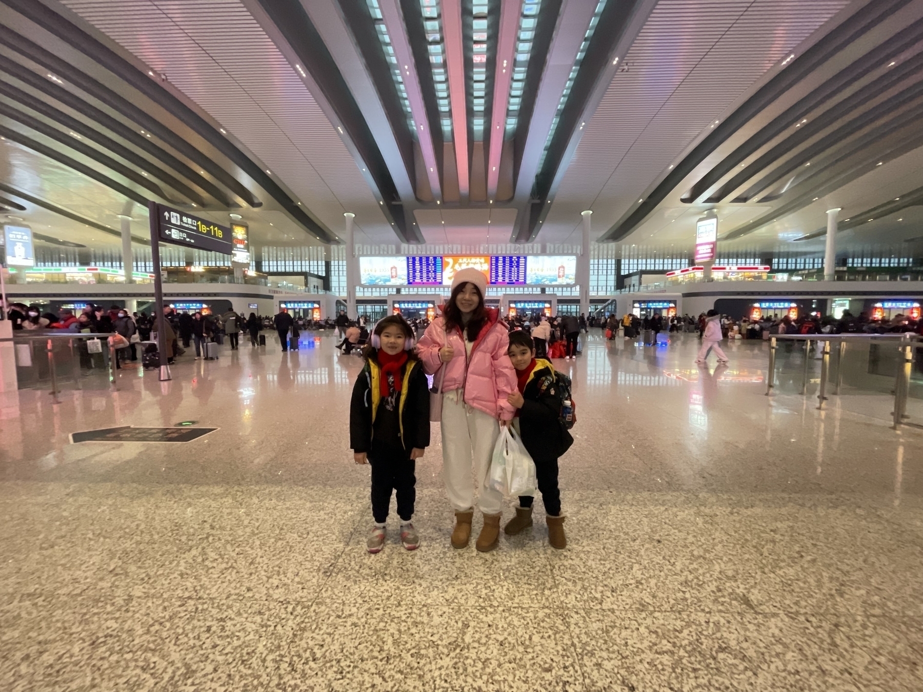 Women and two children stood in a Chinese train station