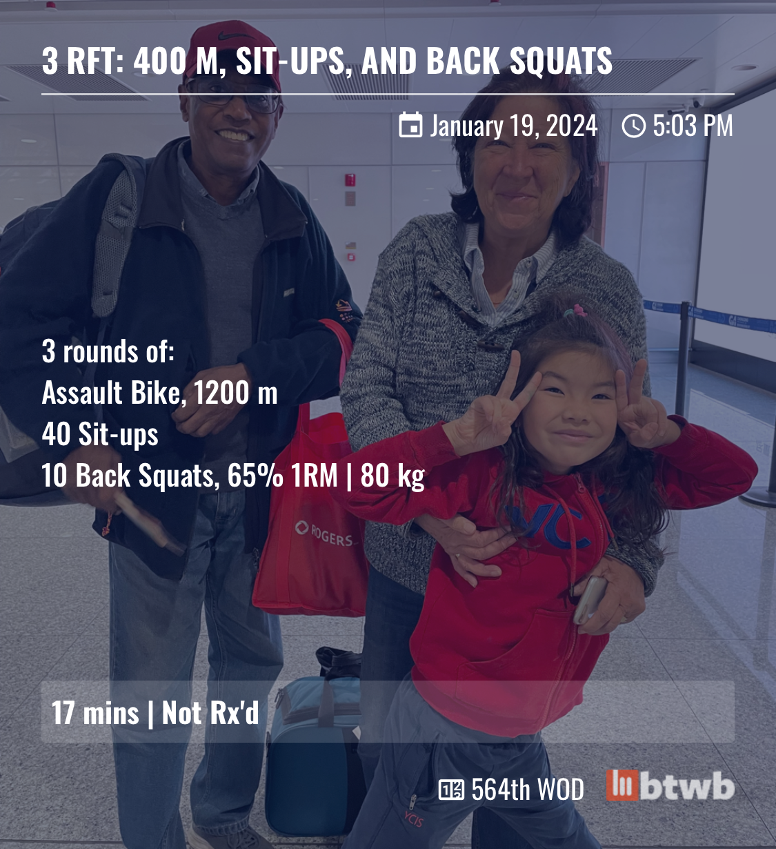 my workout (3 rounds of 1200m Assault bike, 40 sit ups and 10 back squats at 80kg) over the top of a photo of my parents with my daughter at the airport