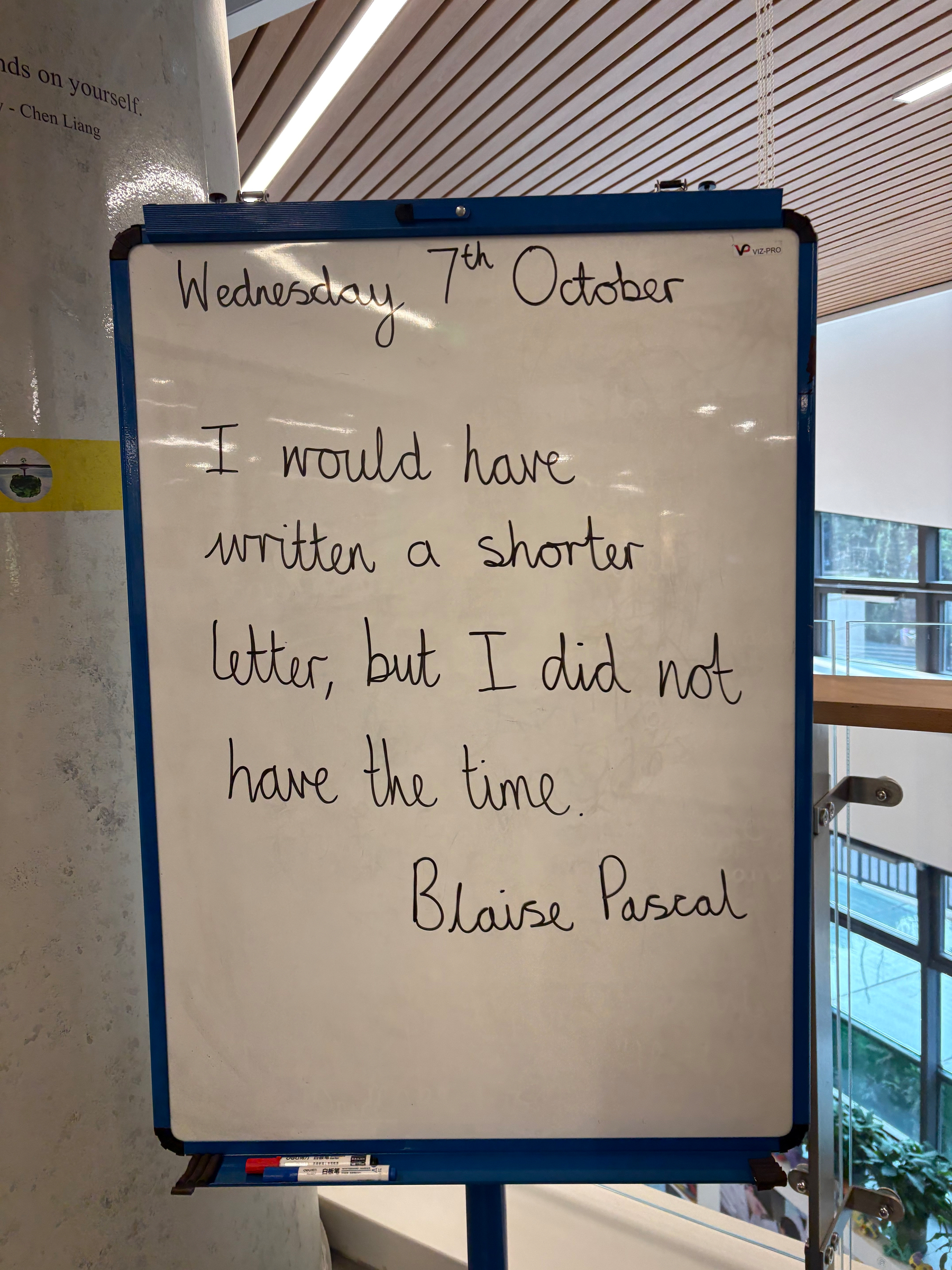 Auto-generated description: Written on a whiteboard is the date Wednesday 7th October along with a quote by Blaise Pascal that reads, I would have written a shorter letter, but I did not have the time.