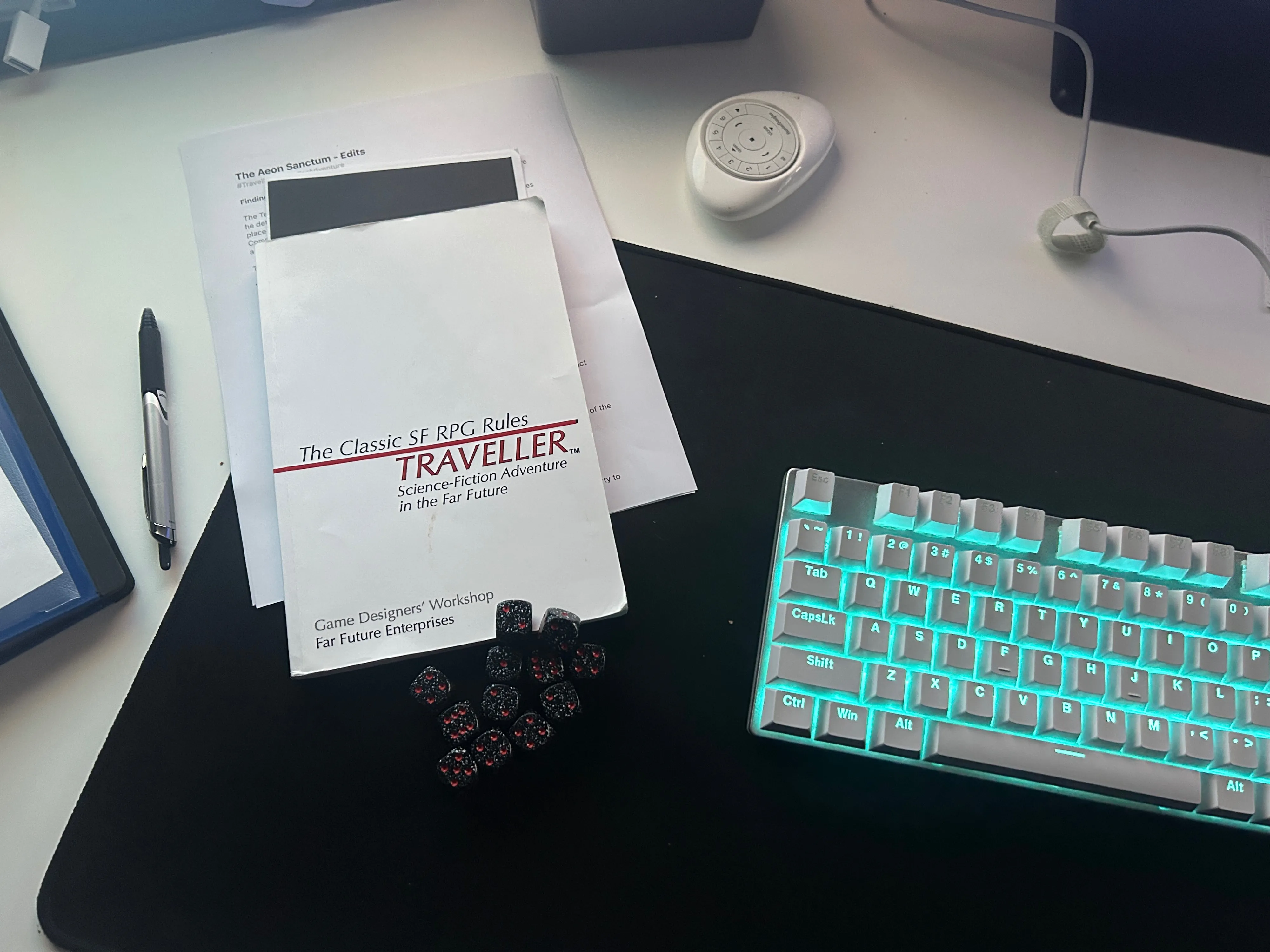 Traveller RPG rulebook and computer keyboard and dice