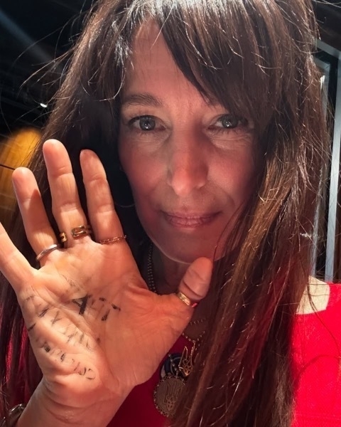 Chantal Kreviazuk selfie, with "That only us command" written on hger hand