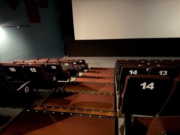 Movie theatre seats with giant numbers on their backs