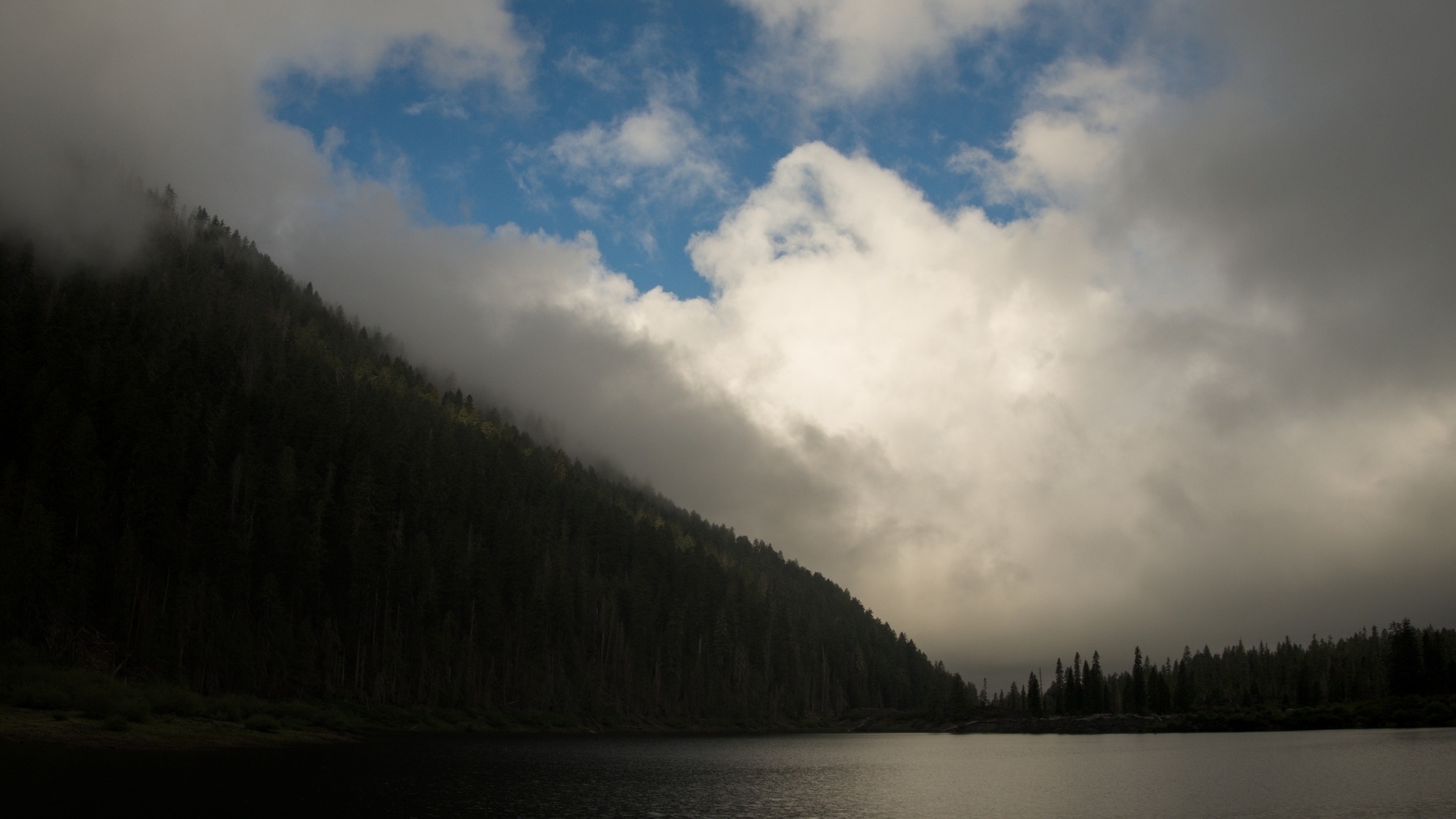 Lake with low clouds and blue sky