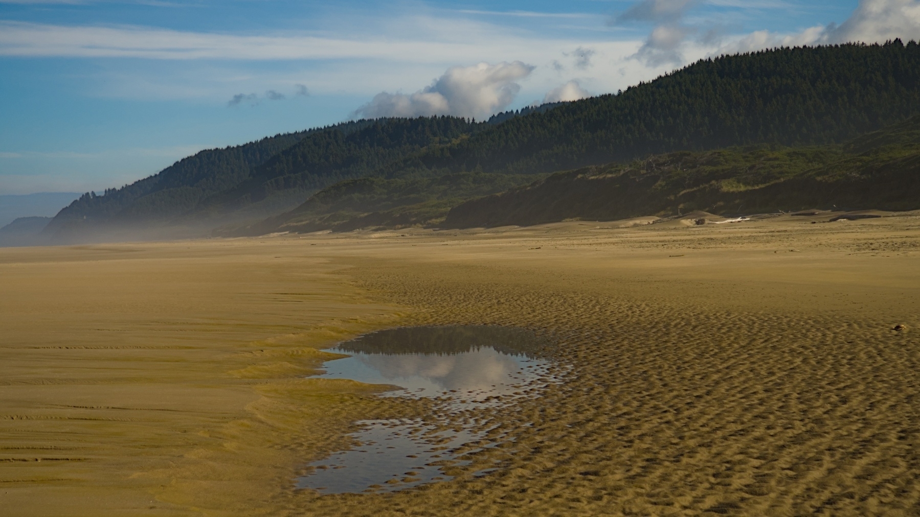 beach, hills, and sky