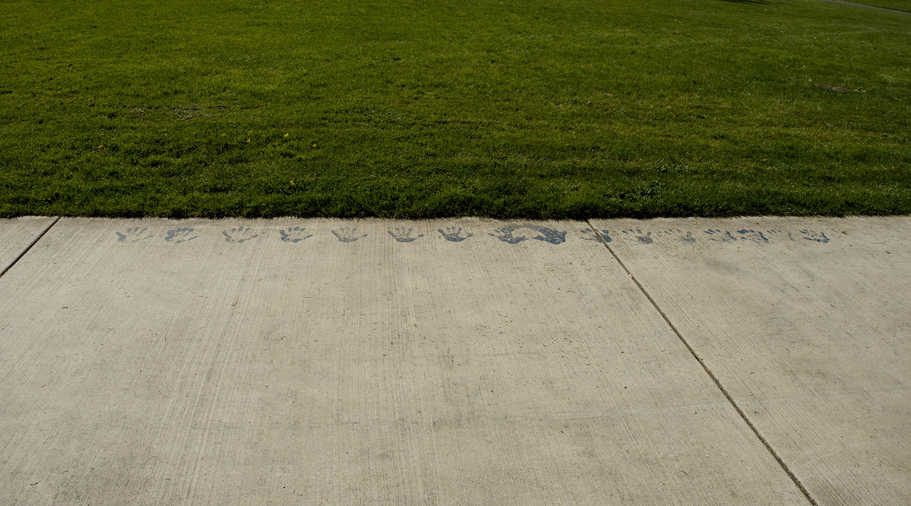 paint handprints on a sidewalk