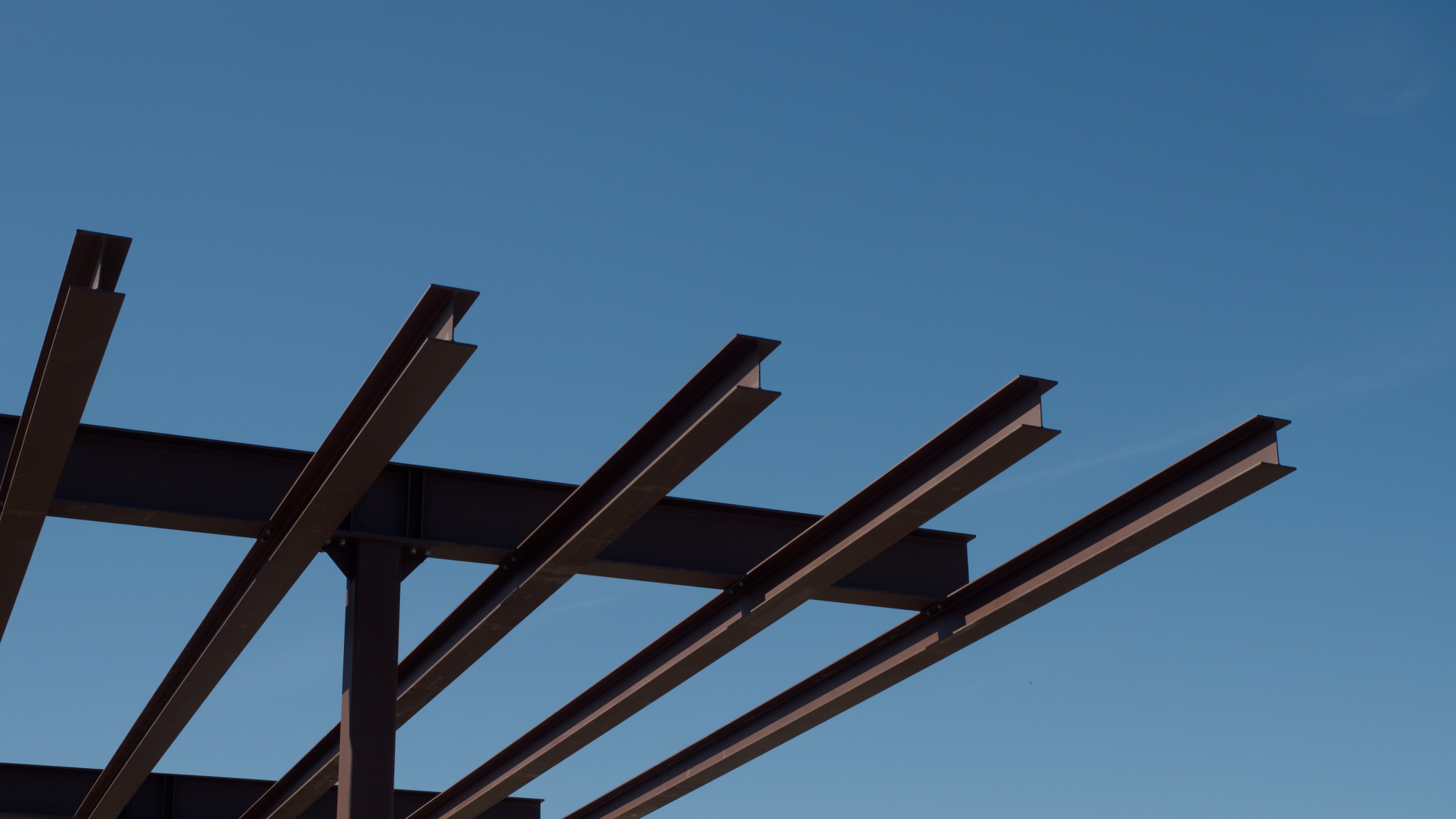 steel beams against a blue sky