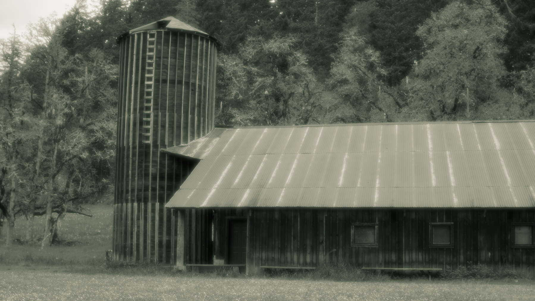 old barn with wooden silo