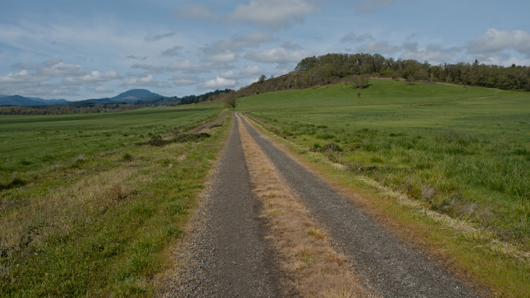 gravel road and green hills