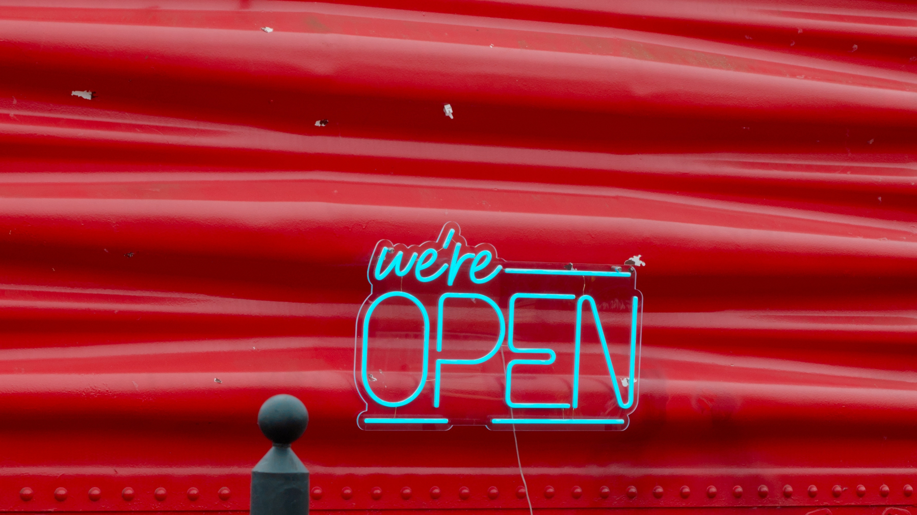 neon sign on red building
