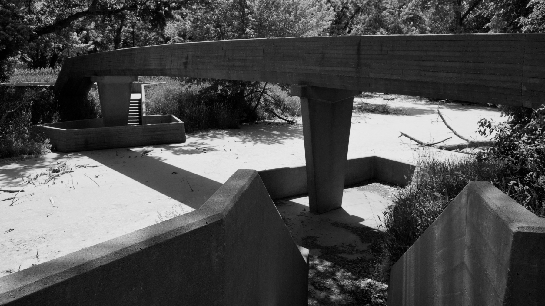 concrete footbridge rendered in black and white