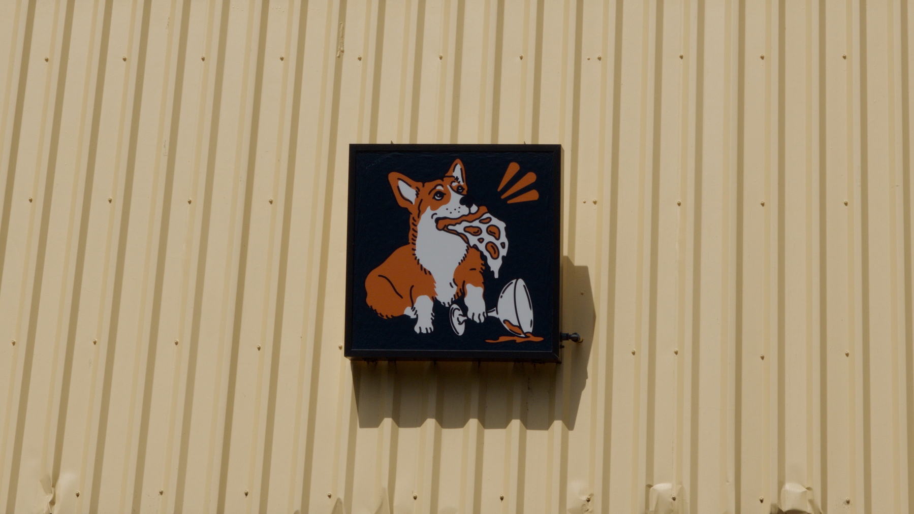 sign showing a corgi with a pizza slice in its mouth